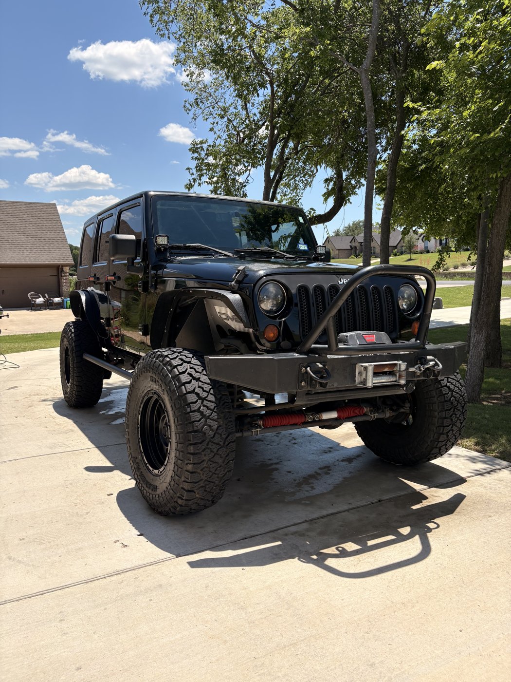 Lifted Jeep detailed and glossy in a driveway
